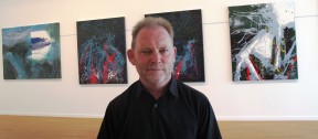 Colin Gibbs with paintings from the series After the rain falls