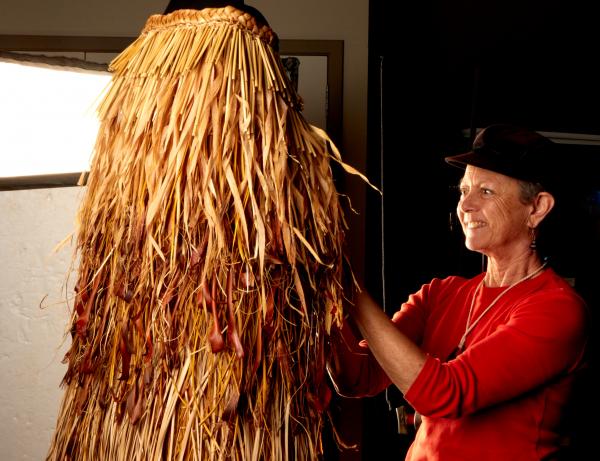 Artist Ruth Port with her weaving titled He Kakahu o Papatuanuku.2